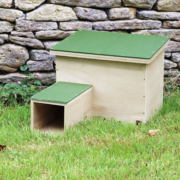 Large wooden hedgehog house in  the garden