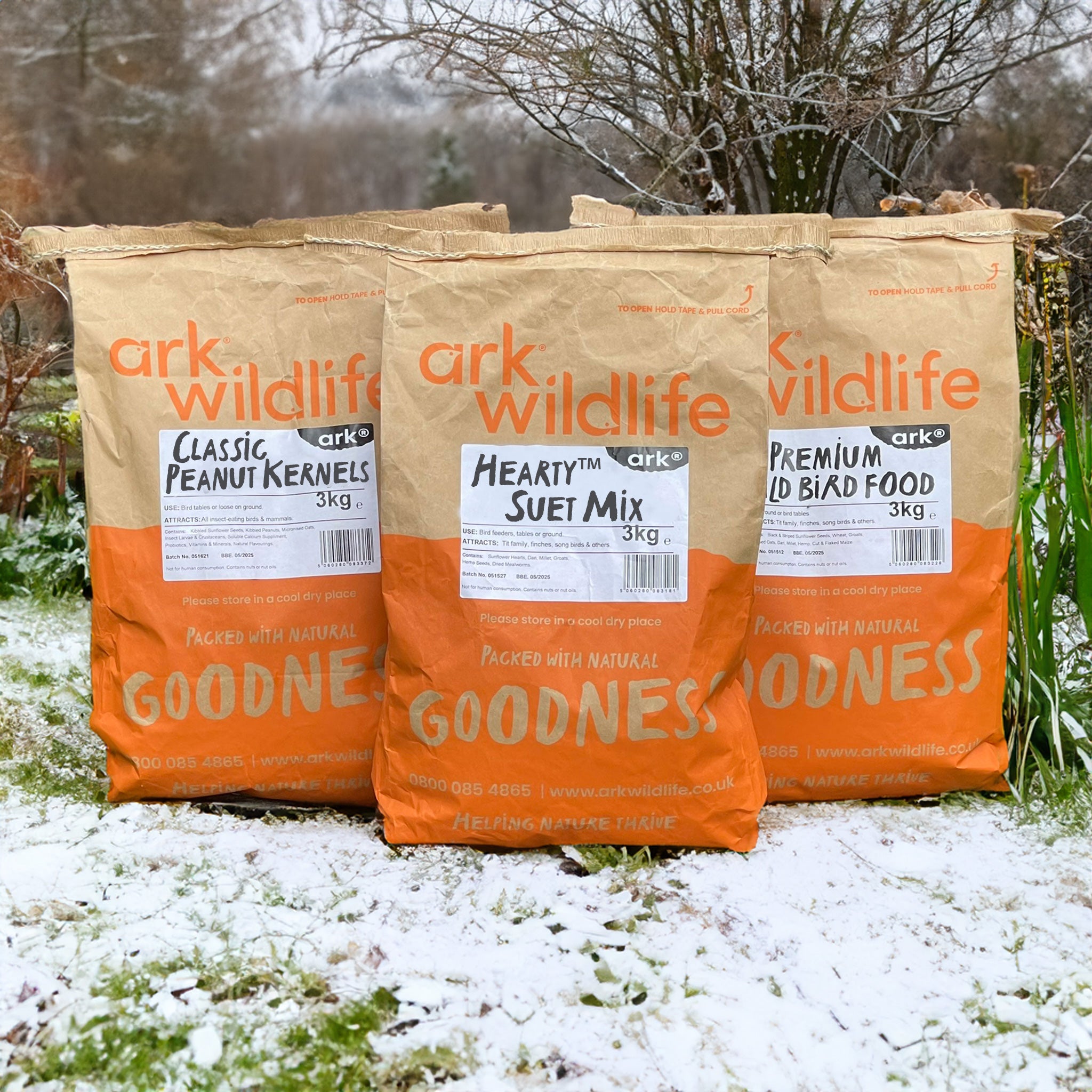 Selection of bird foods in a snowy garden